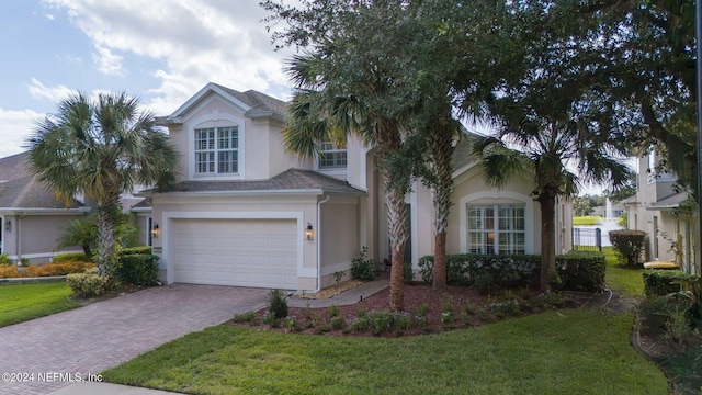 view of front facade with a front yard and a garage