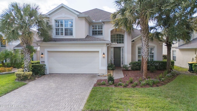 view of front facade featuring a garage and a front yard