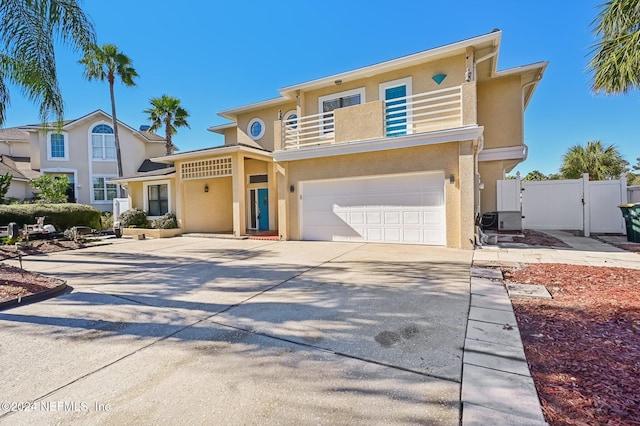 view of front of property featuring a balcony and a garage