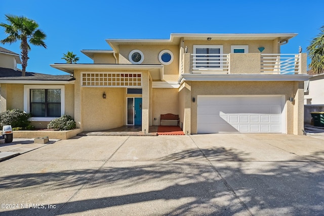 view of front facade featuring a balcony and a garage