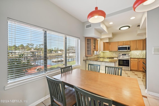 dining area with light tile patterned floors and sink