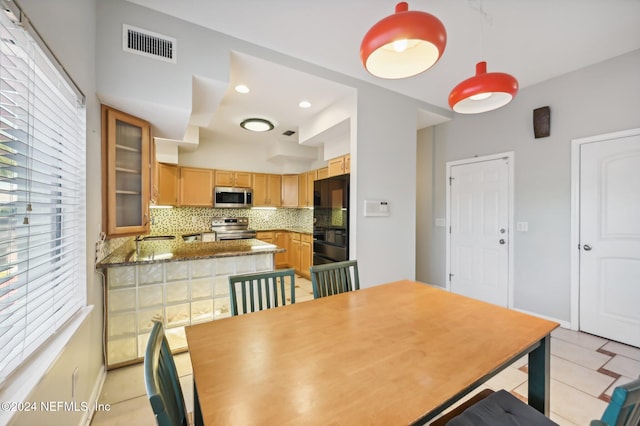 dining space featuring light tile patterned flooring