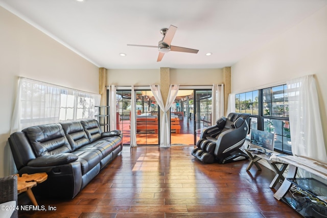 living room featuring ceiling fan and dark hardwood / wood-style flooring