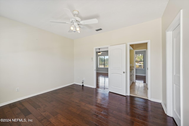 interior space with ceiling fan and dark hardwood / wood-style flooring