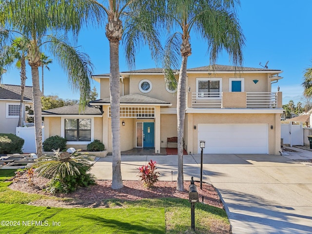 view of front of home featuring a balcony and a garage