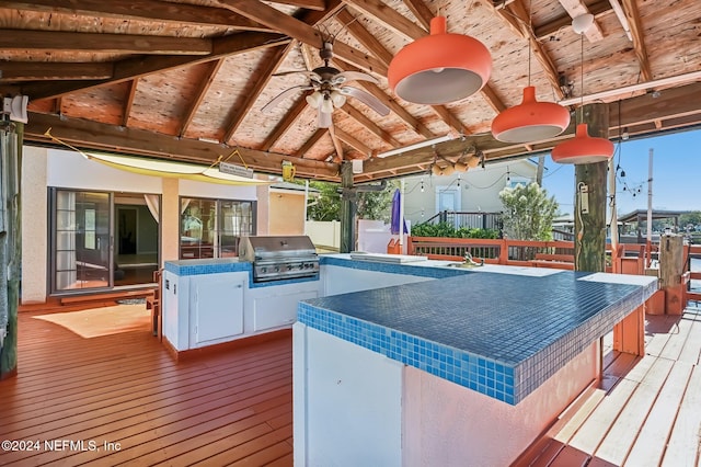 deck featuring ceiling fan, exterior kitchen, a grill, a gazebo, and a bar