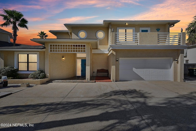 prairie-style home with a balcony and a garage