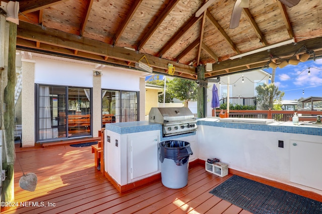 wooden terrace featuring a gazebo, ceiling fan, and a grill