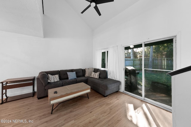 living room featuring ceiling fan, light hardwood / wood-style flooring, and high vaulted ceiling