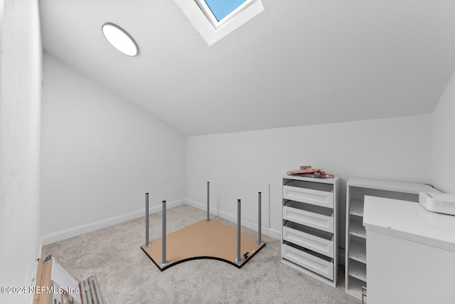 bonus room featuring vaulted ceiling with skylight and light colored carpet