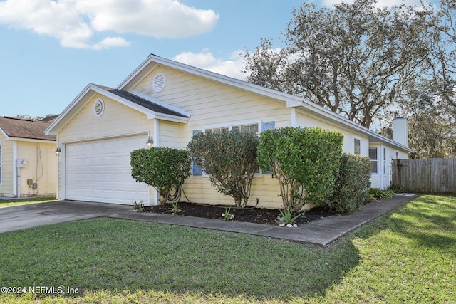 single story home featuring a front lawn and a garage