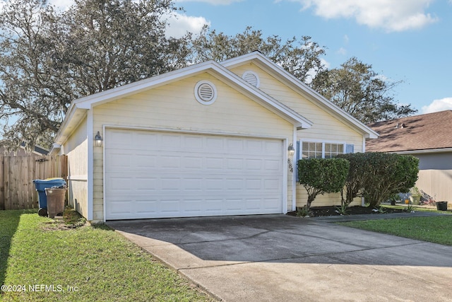 ranch-style home with a front lawn and a garage