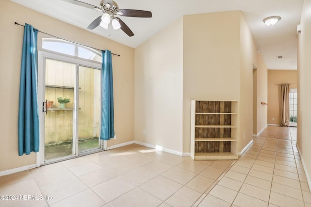 spare room featuring light tile patterned floors and ceiling fan