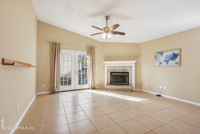 unfurnished living room featuring ceiling fan, french doors, light tile patterned flooring, and lofted ceiling