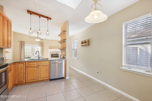 kitchen featuring pendant lighting, ceiling fan, sink, and stainless steel appliances