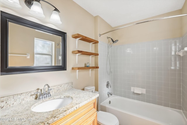 full bathroom featuring vanity, toilet, and tiled shower / bath