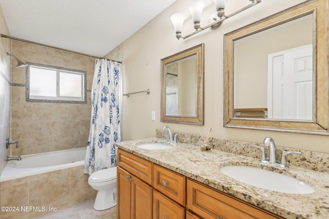 full bathroom with tile patterned floors, vanity, a textured ceiling, shower / bathtub combination with curtain, and toilet