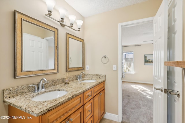 bathroom featuring vanity and a textured ceiling