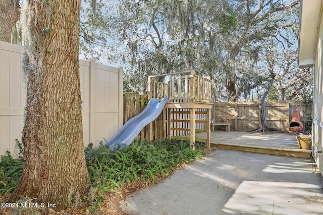 view of jungle gym featuring a deck