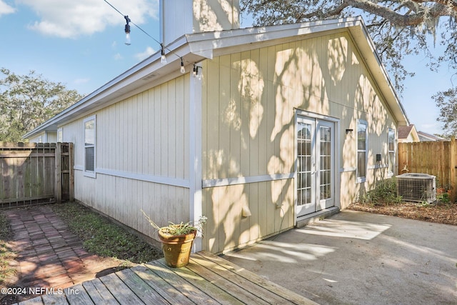 view of side of home featuring central air condition unit and a patio