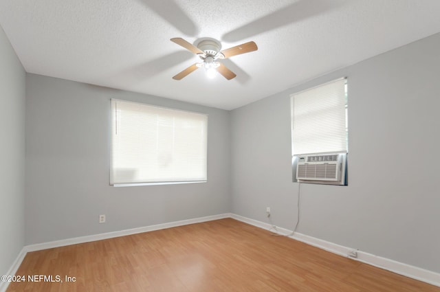 5813 Doeboy St, Jacksonville, FL 32208 - spare room featuring light wood-style floors, cooling unit, ceiling fan, baseboards, and a textured ceiling