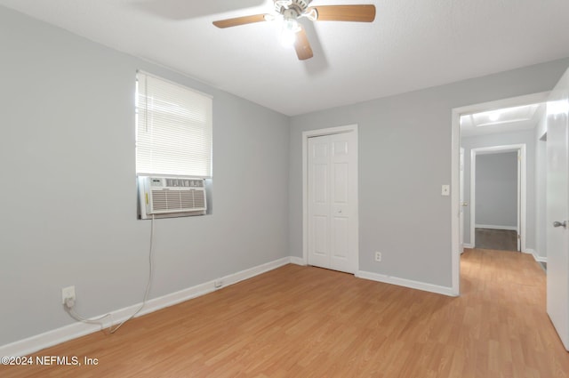 5813 Doeboy St, Jacksonville, FL 32208 - unfurnished bedroom with light wood finished floors, cooling unit, baseboards, and a closet