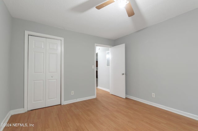 5813 Doeboy St, Jacksonville, FL 32208 - unfurnished bedroom with light wood finished floors, a closet, baseboards, and ceiling fan