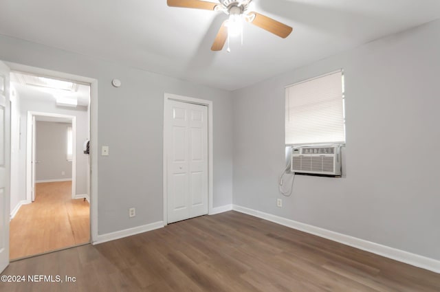 5813 Doeboy St, Jacksonville, FL 32208 - unfurnished bedroom featuring wood finished floors, a closet, baseboards, cooling unit, and a ceiling fan