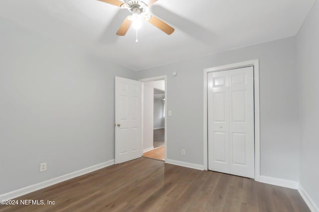 5813 Doeboy St, Jacksonville, FL 32208 - unfurnished bedroom featuring baseboards, wood finished floors, ceiling fan, and a closet