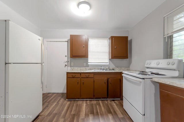 5813 Doeboy St, Jacksonville, FL 32208 - kitchen with white appliances, a sink, light countertops, and wood finished floors