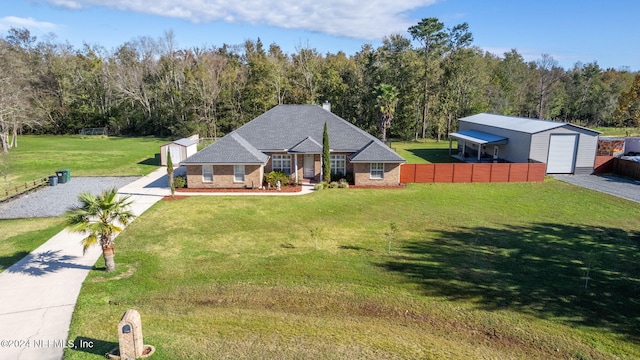 view of front facade featuring a front lawn, an outdoor structure, and a garage