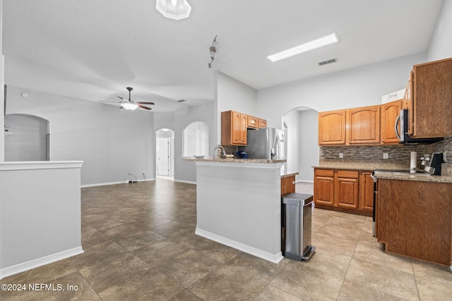 kitchen with ceiling fan, sink, tile patterned flooring, backsplash, and appliances with stainless steel finishes