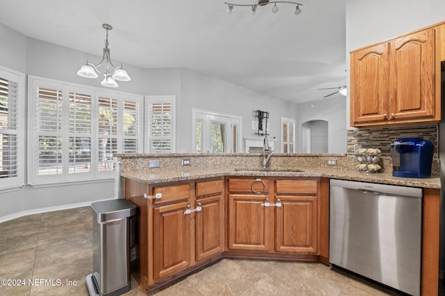 kitchen with stainless steel dishwasher, ceiling fan with notable chandelier, light stone counters, and decorative backsplash