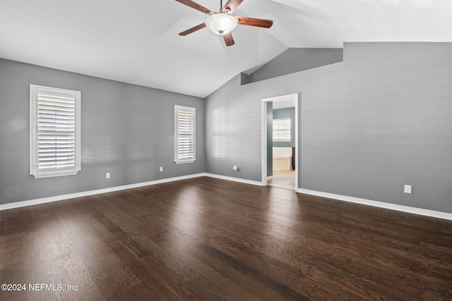 empty room featuring a textured ceiling, ceiling fan, wood-type flooring, and vaulted ceiling