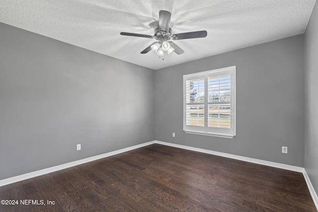 spare room featuring ceiling fan, a textured ceiling, and dark wood-type flooring