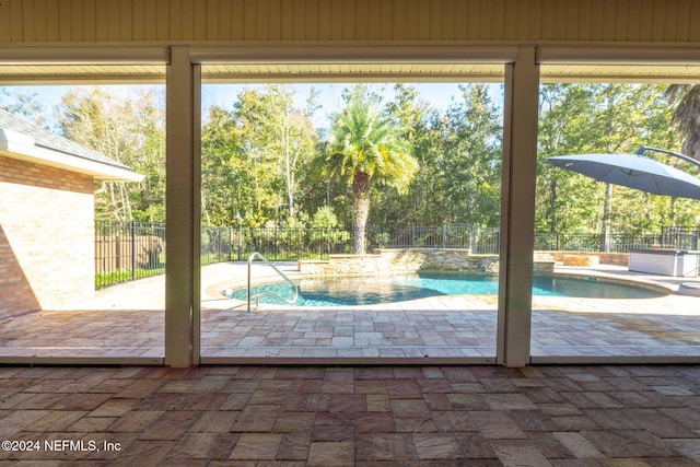 doorway to outside featuring wood walls and a healthy amount of sunlight