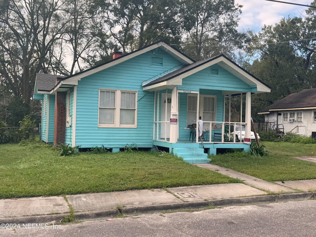 bungalow-style house featuring a porch and a front yard