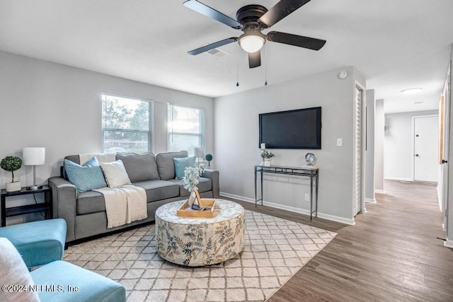 living room featuring light hardwood / wood-style floors and ceiling fan