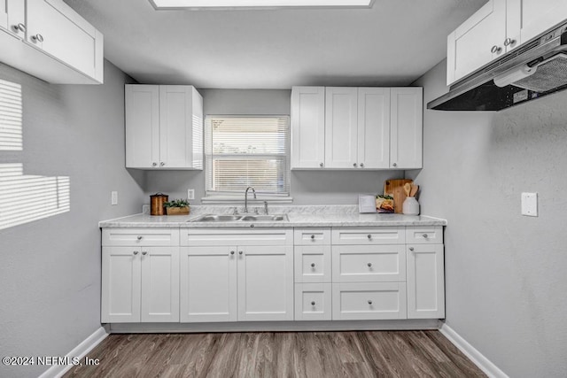 kitchen with white cabinets, dark hardwood / wood-style flooring, and sink