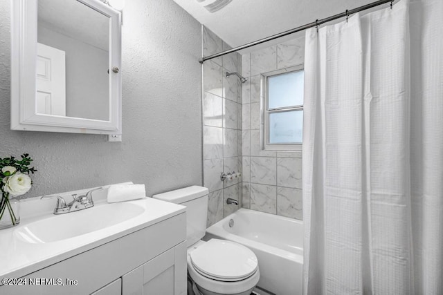 full bathroom with vanity, shower / tub combo, and toilet