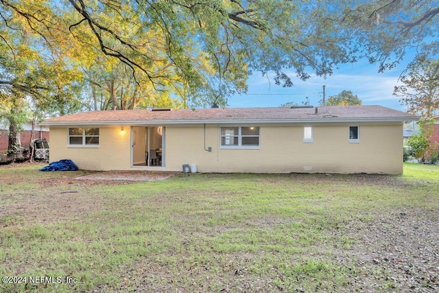 rear view of property with a yard