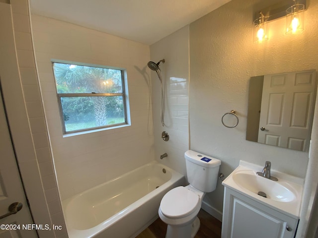 full bathroom with toilet, vanity, and tiled shower / bath combo