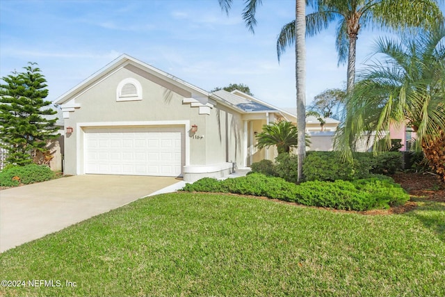 view of front of property featuring a garage and a front lawn