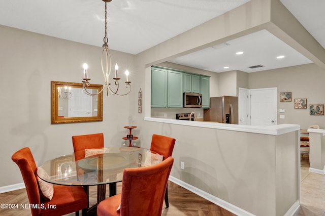 dining room with wood-type flooring and an inviting chandelier