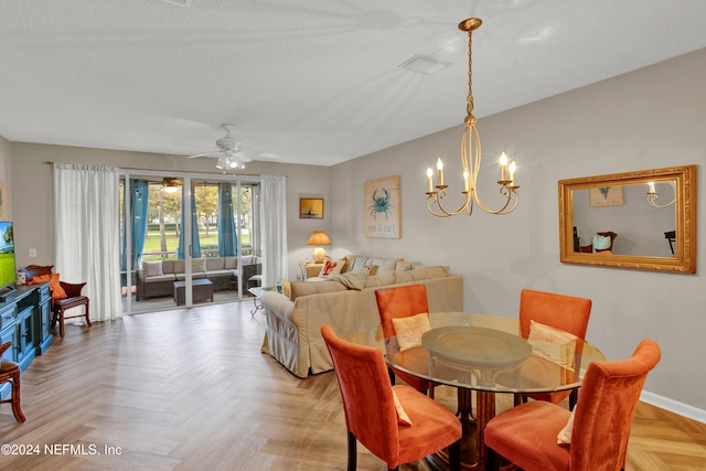 dining area with ceiling fan with notable chandelier and light parquet floors