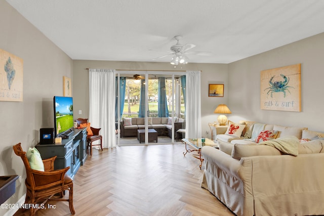 living room with ceiling fan and light parquet flooring