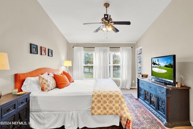 carpeted bedroom featuring ceiling fan and vaulted ceiling