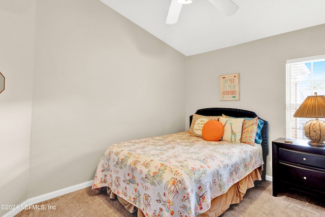 bedroom featuring ceiling fan, light colored carpet, and vaulted ceiling