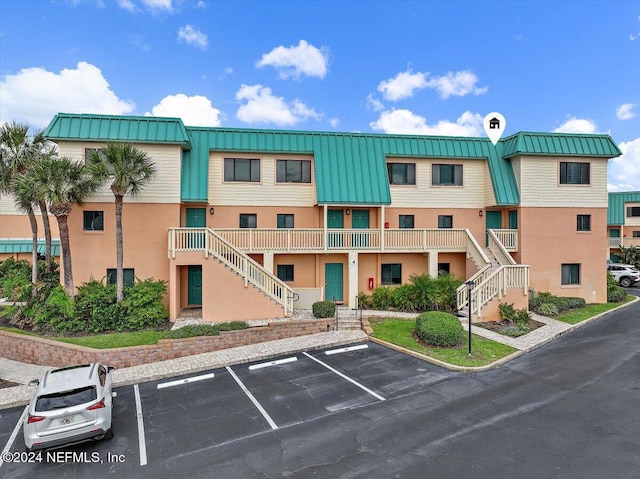 6100 A1A S Unit 419, Saint Augustine, FL 32080 - view of property with stairs and uncovered parking