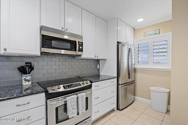 kitchen featuring tasteful backsplash, white cabinetry, light tile patterned floors, and stainless steel appliances